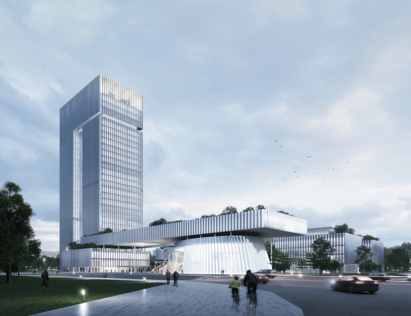 A modern cityscape with a tall glass skyscraper, a lower building with a roof garden and blurred cars and cyclists moving along a wide road under a cloudy sky. Trees and greenery can be seen throughout the scene.