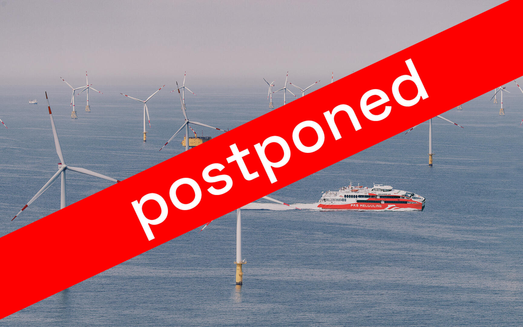 A red ferry sails through an offshore wind farm with many wind turbines, overlaid by a bold red banner with the word “postponed” in large white letters.