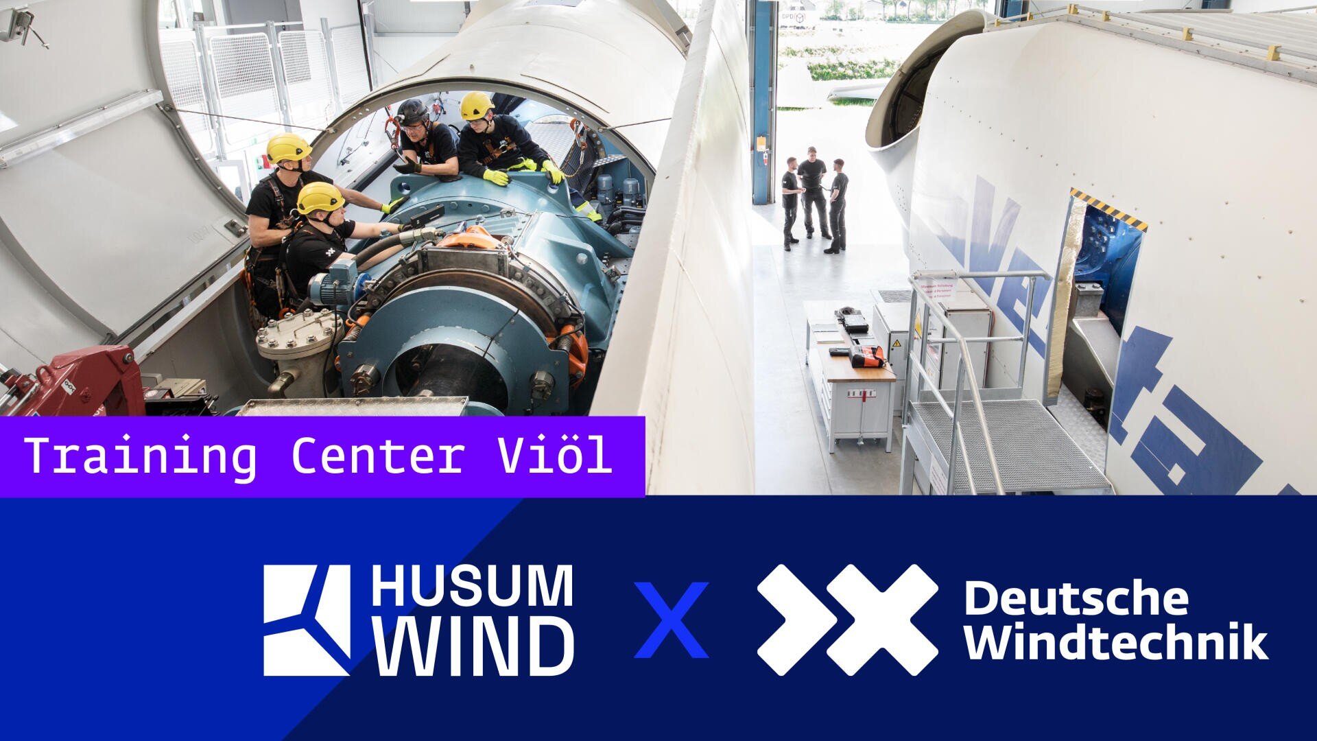 Arbeiter in Schutzkleidung trainieren an Windkraftanlagen in einer Anlage. Das Bild enthält Logos für Husum Wind und Deutsche Windtechnik sowie ein Schild mit der Aufschrift Training Center Viöl.