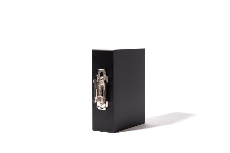 A closed black lever arch file folder stands upright on a white background, showing its metal clasp mechanism facing forward.